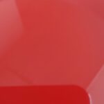 A close up of a red plastic plate.